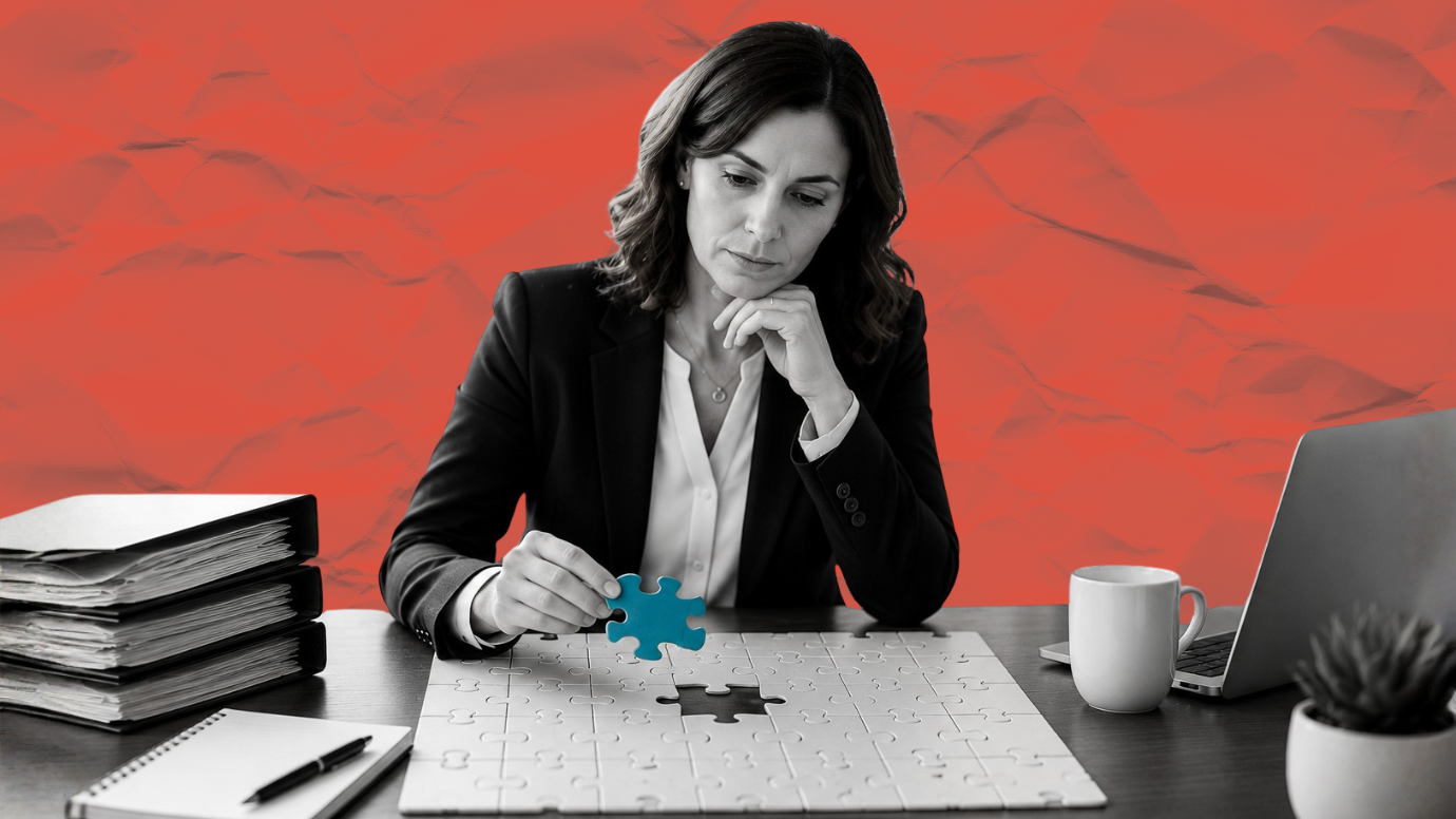 Woman attorney sitting at her desk placing the final puzzle piece into a puzzle. 