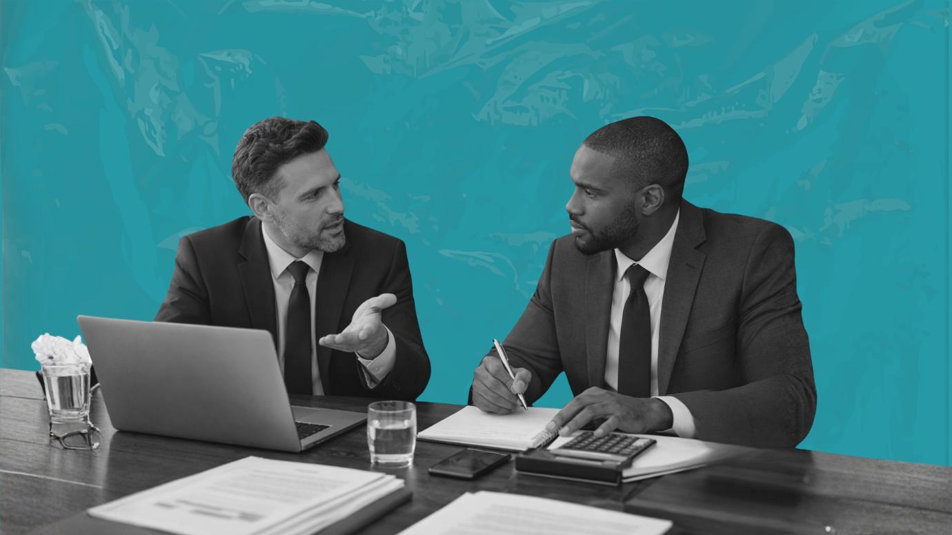 Two male attorneys discussing their firm's insurance coverage. 