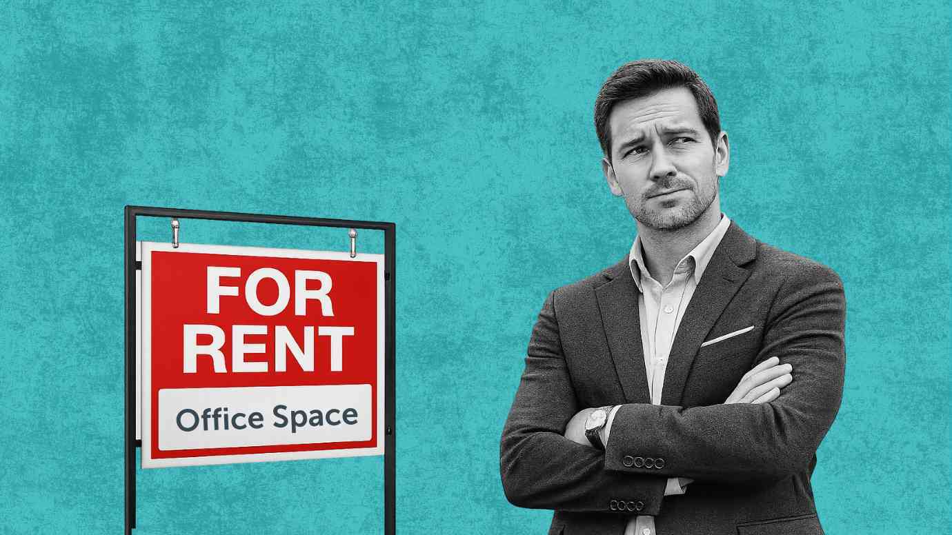 Man standing with his arms crossed in front of an Office Space For Rent sign.